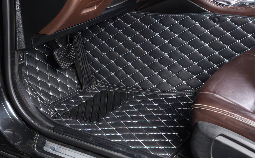 Black custom car mats fitted in the driver footwell